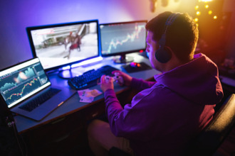 male gamer sitting at home and playing games online on computer for money
